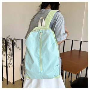 Detailed view of lightweight macaron blue and green waterproof yoga backpack with vertical zipper