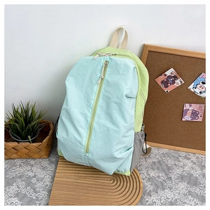 Close-up of waterproof nylon yoga backpack with colorful patchwork and vertical zipper