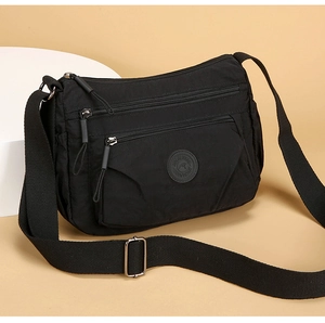 Detail view of the black waterproof nylon bag with multi-layer zipper compartments