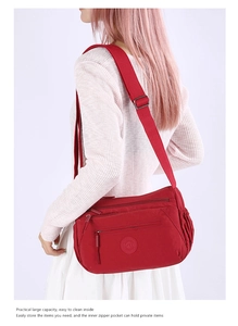 Red nylon crossbody bag with multi-zipper pockets and large capacity for travel