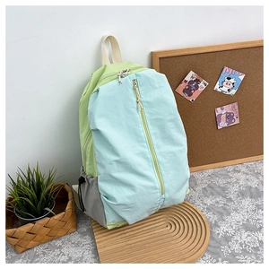 Detail of waterproof nylon yoga backpack with three-color patchwork and front zipper