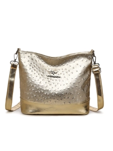 Detailed view of the gold ostrich texture and metal logo on the Boston crossbody bag