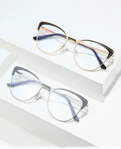 Detailed macro view of gold and silver cat-eye metal frames with stylish contrast accents
