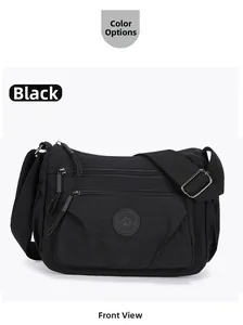 Front detail of black nylon crossbody bag with multi-zipper pockets and wide strap