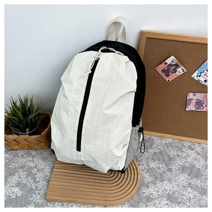 Detail of waterproof yoga backpack with tricolor patchwork and vertical front zipper