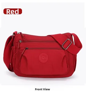 Front view of a red waterproof nylon shoulder bag featuring multiple zippered pockets