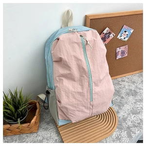 Detail of pink and blue color-block waterproof nylon yoga backpack with drawstring pockets