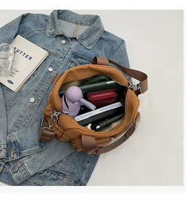 Brown nylon crossbody bag showing spacious interior with umbrella and wallet storage