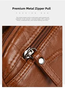 Détail d'une fermeture éclair en métal avec tirette sur un sac en cuir texturé marron