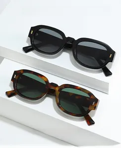 Detail of vintage square sunglasses with thick frames and golden metal temple hinges