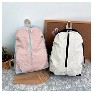 Close-up of minimalist waterproof nylon backpacks with front zipper and side pocket details