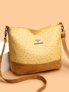 Modern Boston bag in yellow ostrich texture and brown leather with shoulder strap