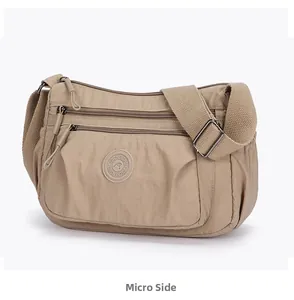 Side view of khaki multi-pocket nylon crossbody bag with adjustable wide strap and logo