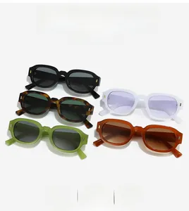 Flat lay of retro wide-frame sunglasses in multiple colors with metallic stud details