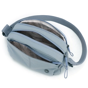 Dusty blue lightweight puff shoulder bag with three zipper compartments and wide strap