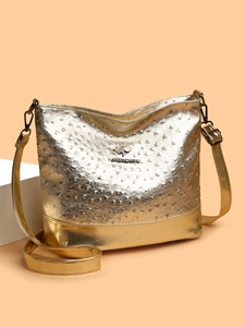 Detailed close-up of metallic gold Boston bag with ostrich texture and gold logo