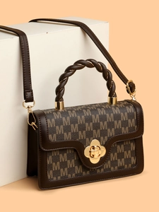 Retro brown monogram handbag with woven top handle and gold floral clasp design