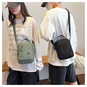 Detail of army green and black waterproof nylon crossbody bags with adjustable straps