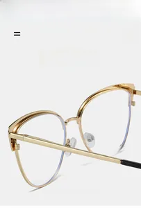 Detailed shot of golden metal cat eye frames with silicone nose pads and black temple tips