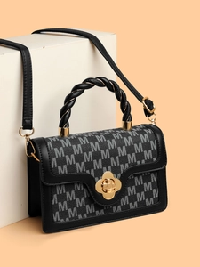 Classic monogram crossbody bag with a gold flower lock and a twisted top handle