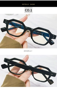 Close-up of black hexagonal sunglasses temples showing SZ2002 model and CE certification