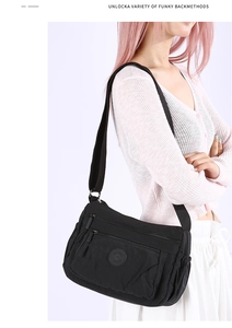 Detail view of water-resistant nylon shoulder bag with multi-layer zipper compartments