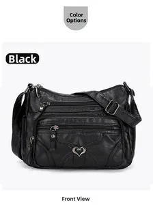 Détail frontal du sac bandoulière noir multi-zip avec logo cœur et texture en cuir souple