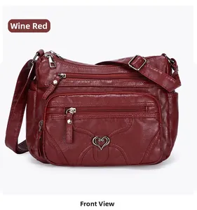 Vue de face du sac à bandoulière en cuir PU bordeaux avec plusieurs poches zippées