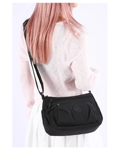 Adjustable wide strap detail on a durable black nylon crossbody bag for daily commute