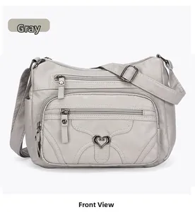 Vue détaillée du sac bandoulière gris en similicuir avec plusieurs poches zippées
