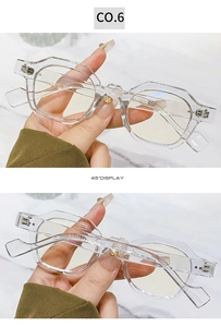 Detail of octagonal transparent glasses frame with gold heart bridge and metal hinges