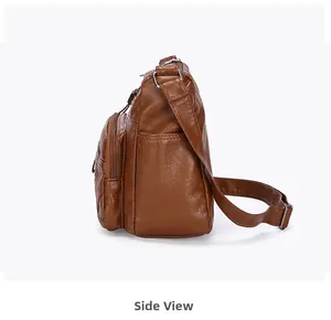 Vue latérale détaillée du sac à bandoulière en cuir souple marron avec plusieurs fermetures