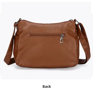 Vue arrière du sac bandoulière en cuir marron avec poche zippée fonctionnelle