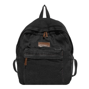 Minimalist black denim backpack with large capacity and brown leather zipper pull details