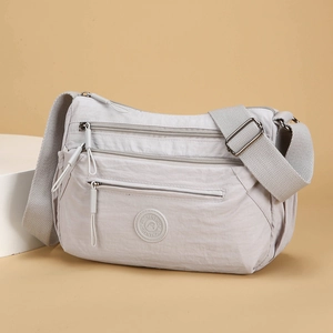 Light gray multi-layer Oxford nylon crossbody bag with adjustable strap and zip pockets