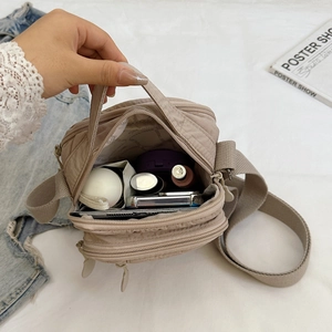 Beige nylon crossbody bag with multi-layer zipper pockets for daily accessories
