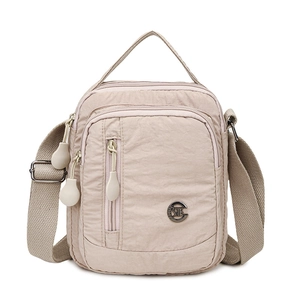 Beige nylon crossbody bag with adjustable strap and multiple zipper pockets