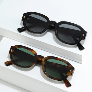 Retro thick-frame sunglasses in black and tortoise finish with metal stud accents