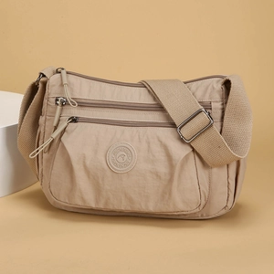 Beige nylon multi-pocket crossbody bag with adjustable strap and silver zippers