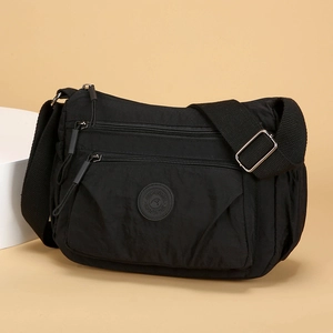 Waterproof black nylon multi-layer crossbody bag with adjustable wide fabric shoulder strap