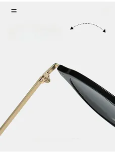 Detailed view of durable metal hinge on oval sunglasses with black acetate frame