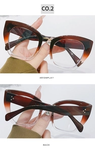 Detail view of cat eye glasses frame in amber gradient with silver rivet accents
