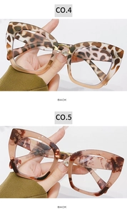 Detail of cat eye glasses frames with leopard print and subtle heart-shaped rhinestones