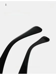 Detail of ergonomic curved black glasses legs with a high-gloss polished finish