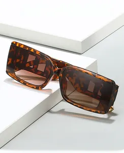Detail of square tortoiseshell sunglasses with 2024 fashion pattern and brown lenses