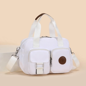 Minimalist white waterproof nylon handbag with multiple pockets and brown leather handles
