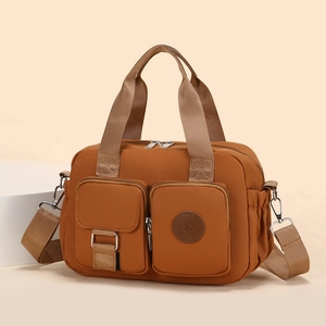 Brown water-resistant nylon handbag with multi-pocket design and crossbody strap