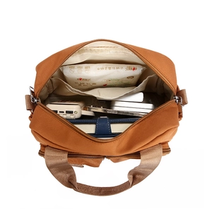 Versatile brown canvas handbag showing spacious interior and storage compartments