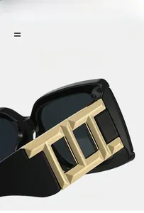 Detail of square sunglasses showing high-elasticity temples and golden metal geometric hinges