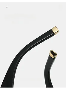 Macro shot of black glossy temples with gold square tips for square sunglasses